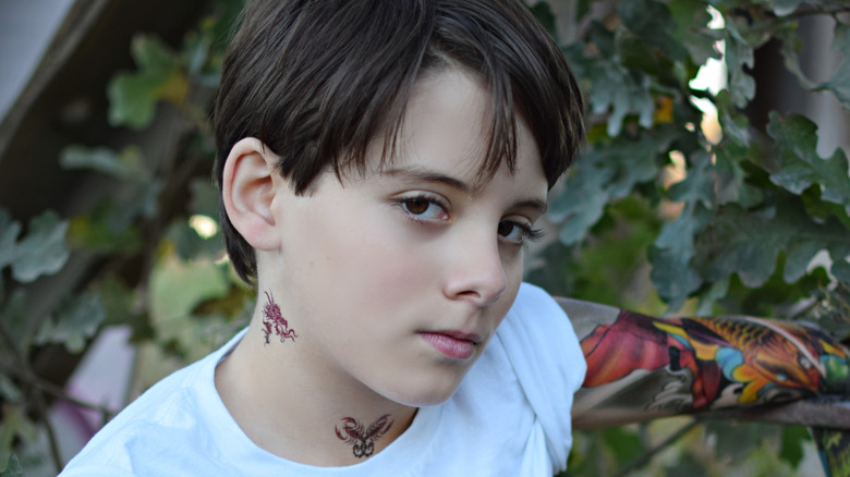 a child with fake tattoos