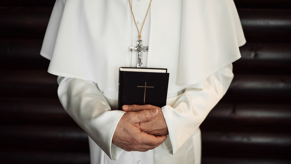 pope holding a bible