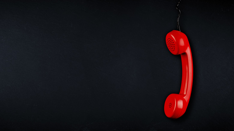 Red landline hanging by chord