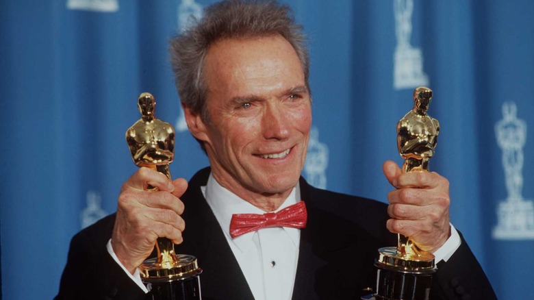 Clint Eastwood holding oscar statues