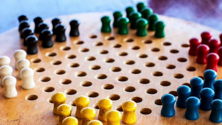 Chinese checkers board with pegs