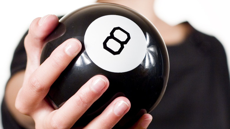 Hand holding a Magic 8 Ball