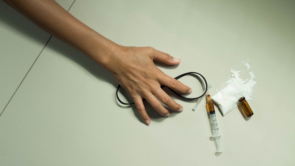 A picture representing someone injecting themselves with heroin with needles