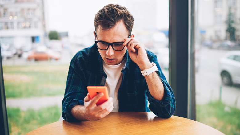 Guy watching something on phone