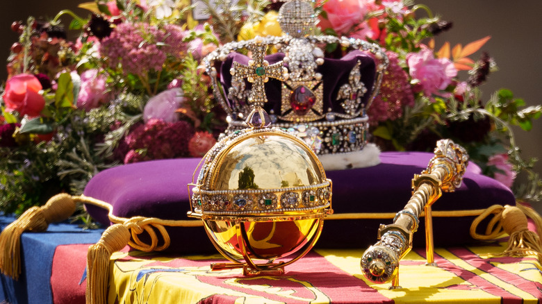 Royal regalia sit on a coffin