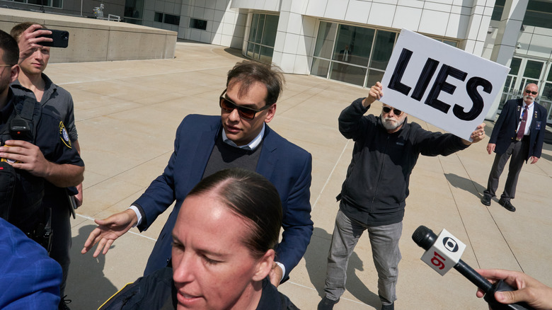 George Santos protestor signs