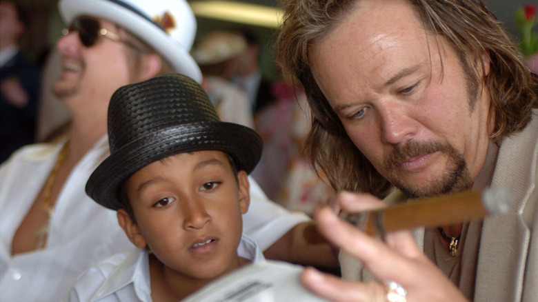 Kid Rock, his son, Travis Tritt looking at something