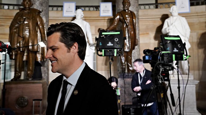 Matt Gaetz walking in front of cameras