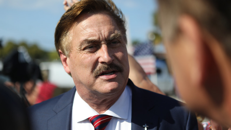 Mike Lindell outside talking in a crowd