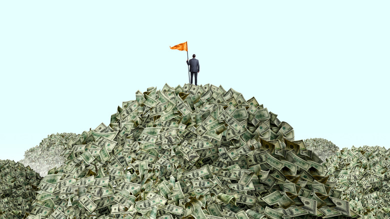 Guy standing on money mountain
