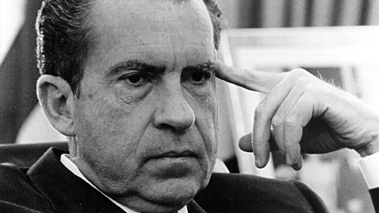 Richard Nixon points to head