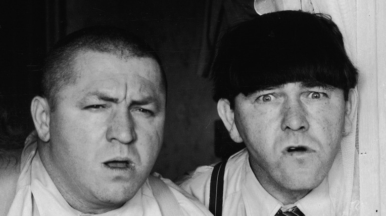 Curly and Moe Howard look befuddled