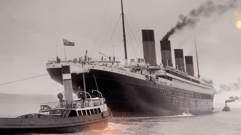 RMS Titanic with smaller boat 