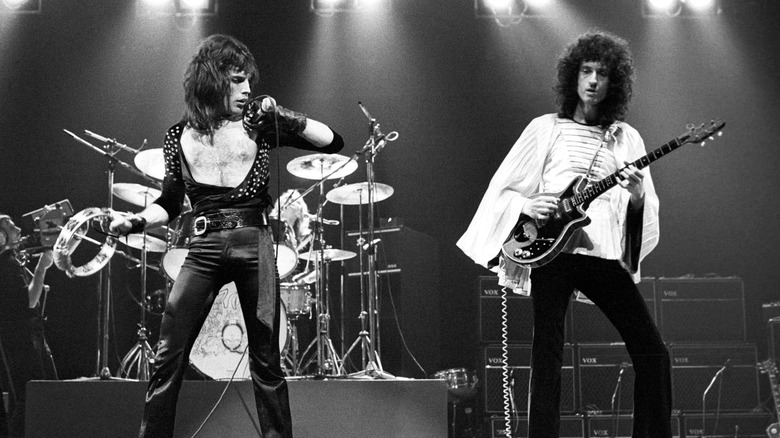 Freddie Mercury onstage singing into microphone