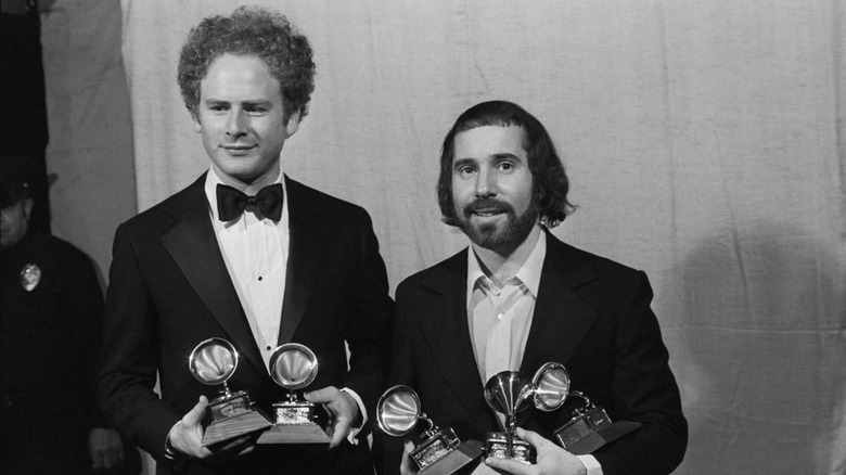 Simon & Garfunkel in suits holding awards in 1970