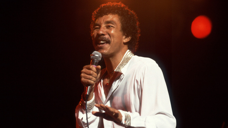 Smokey Robinson singing into microphone