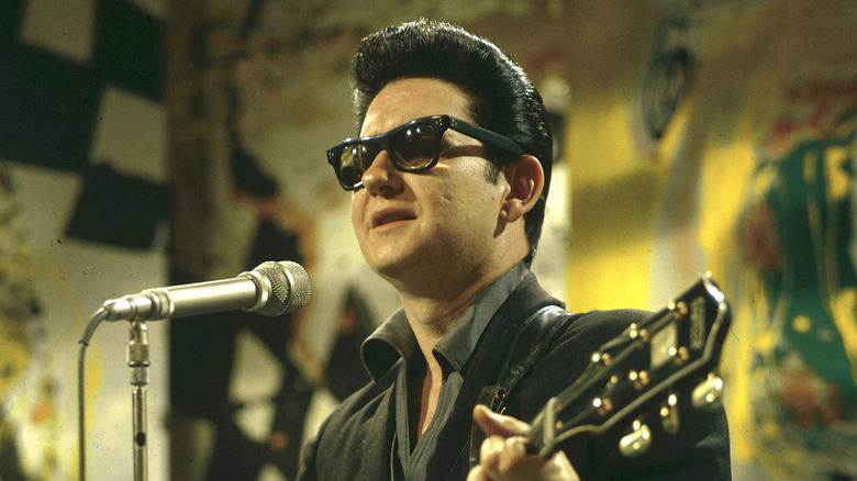 Roy Orbison singing and playing guitar