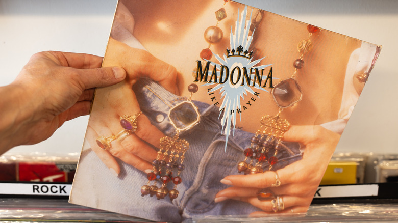 Person picking up Madonna record