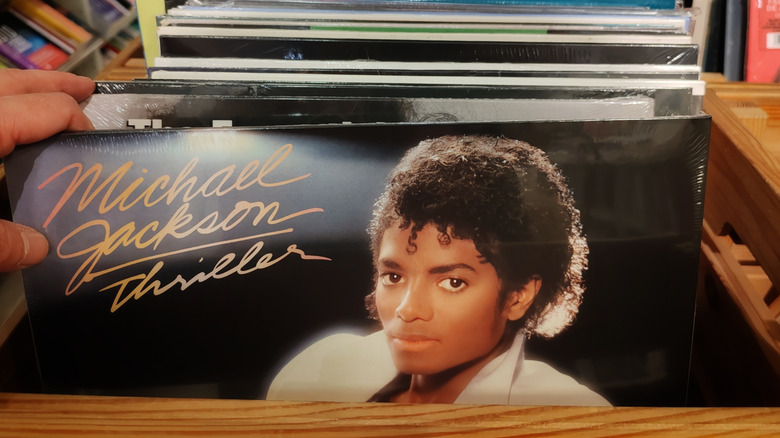 Person pulling out Thriller vinyl