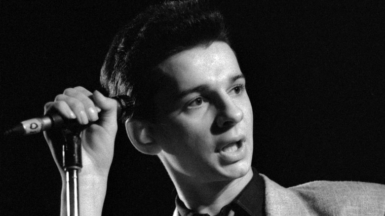 Dave Gahan looking away while grasping mic