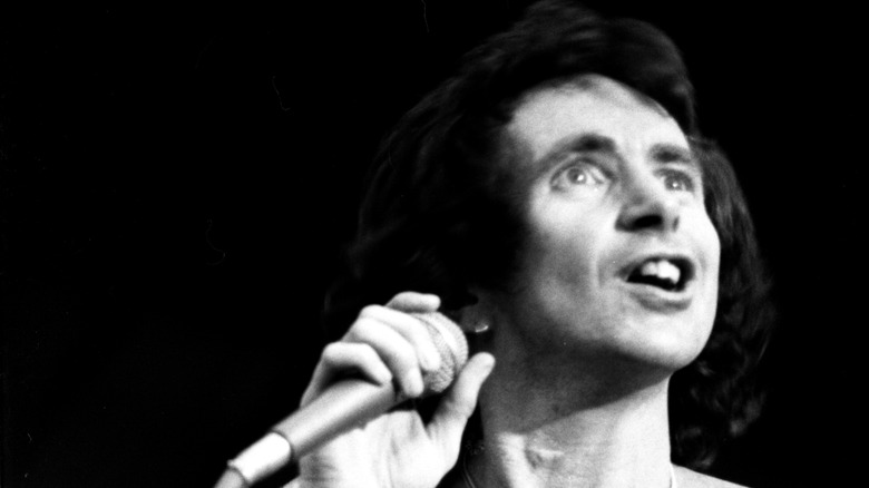 bon scott holding microphone