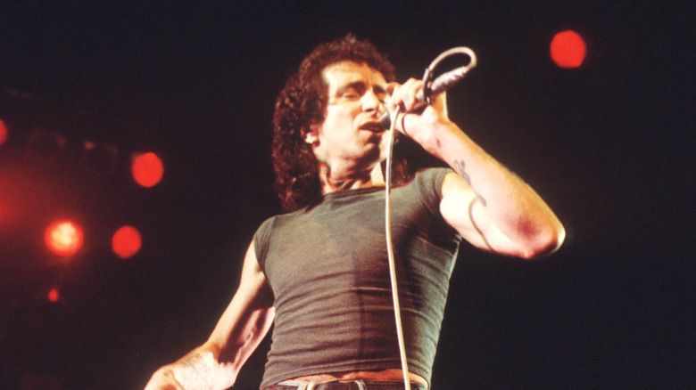 bon scott singing onstage with eyes closed