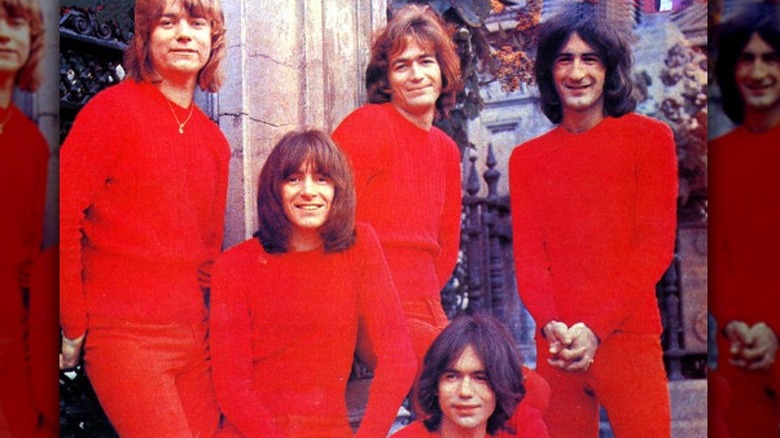 bon scott smiling in red shirt in publicity photo with the valentines