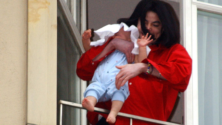 Michael Jackson dangles baby Blanket over balcony