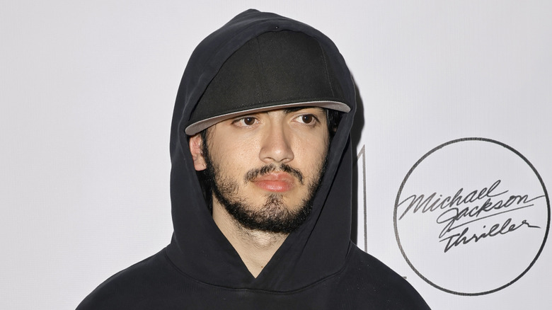 Bigi Jackson wearing cap and hooded sweatshirt