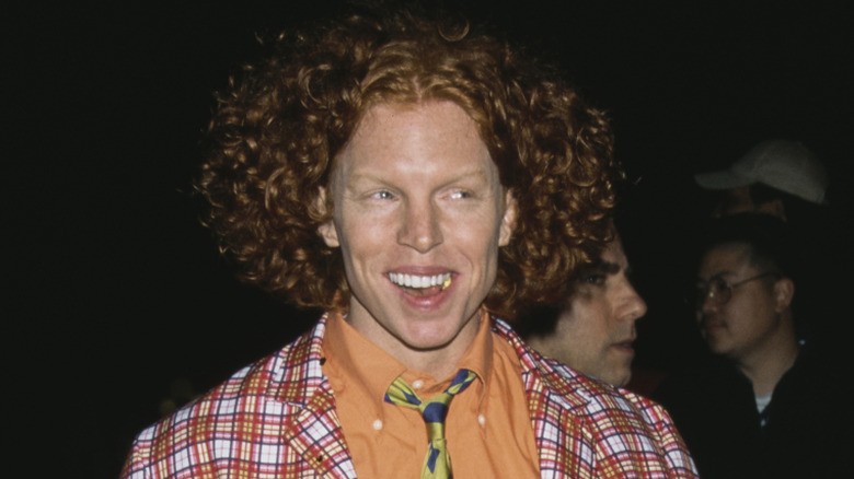 Carrot Top smiling and wearing checkered jacket