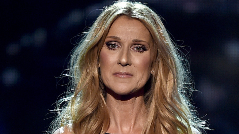 celine dion looking downward sad onstage