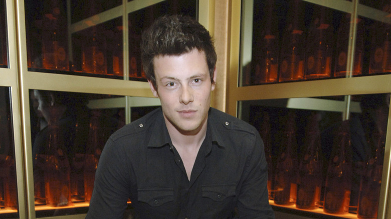Corey Monteith posing in front of a window in 2007