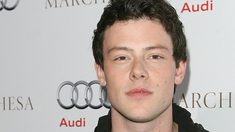 Cory Monteith posing in front of a white background