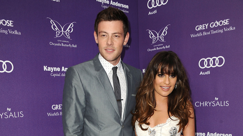 Cory Monteith in grey suit with Lea Michele