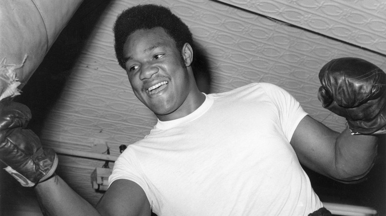 A young George Foreman striking a punching bag