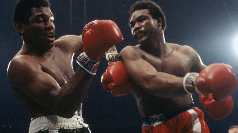 George Foreman swinging a fist at Jimmy Young in 1977