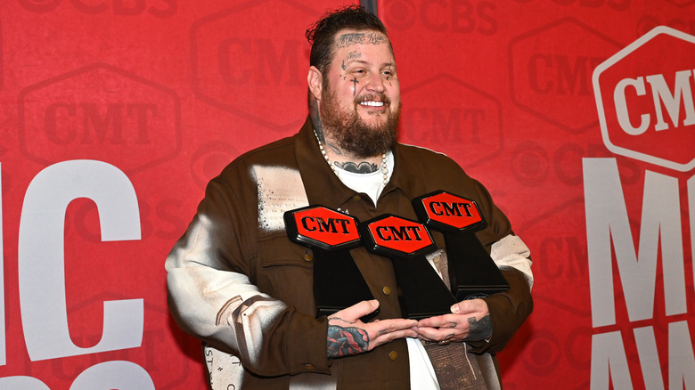 Jelly Roll holding CMT awards
