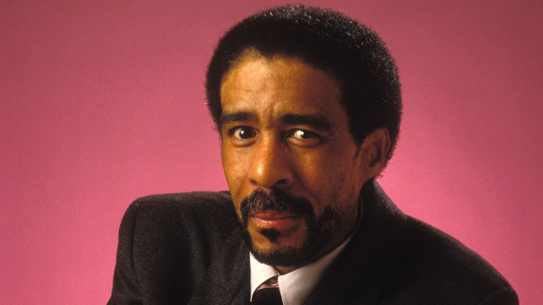 Richard Pryor posing in dark suit and tie