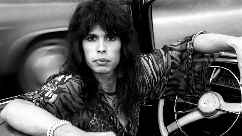 Steven Tyler posing in his car in 1975