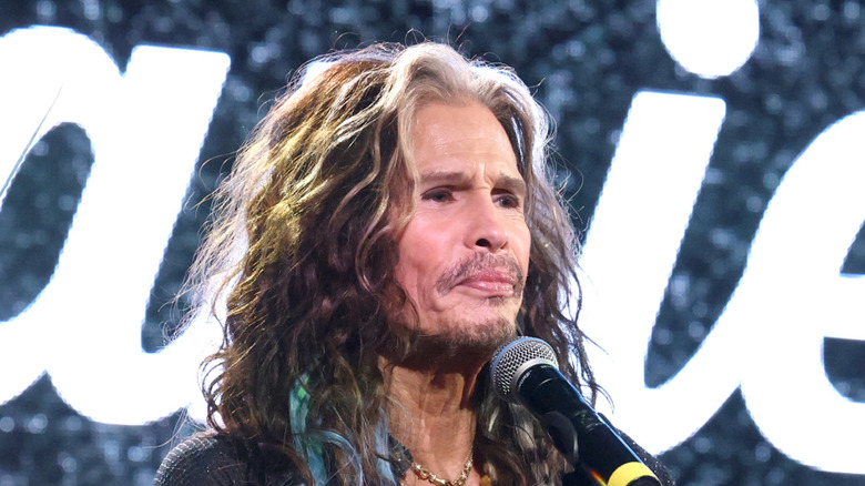 Close up of Steven Tyler standing at a podium