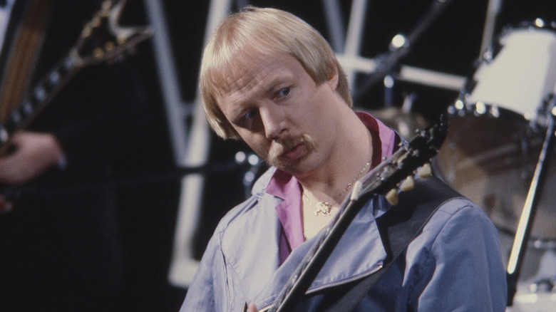Kerry Livgren looks at guitar as he plays during Kansas performance