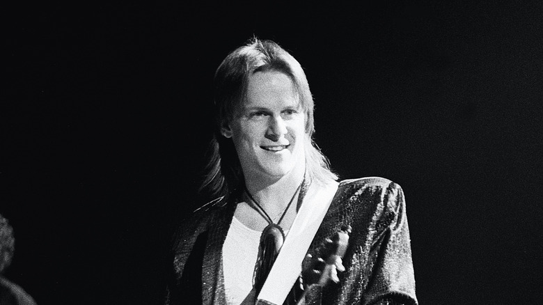 Steve Morse smiling playing guitar for Kansas