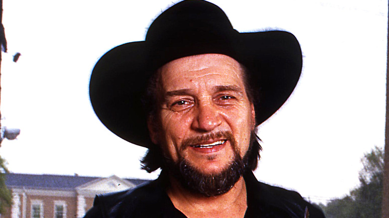 Waylon Jennings smiling in wide brimmed hat