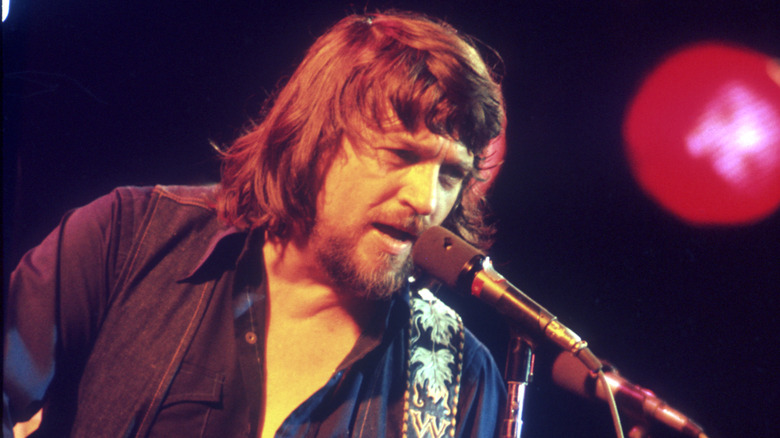 Waylon Jennings singing on stage in the 1970s