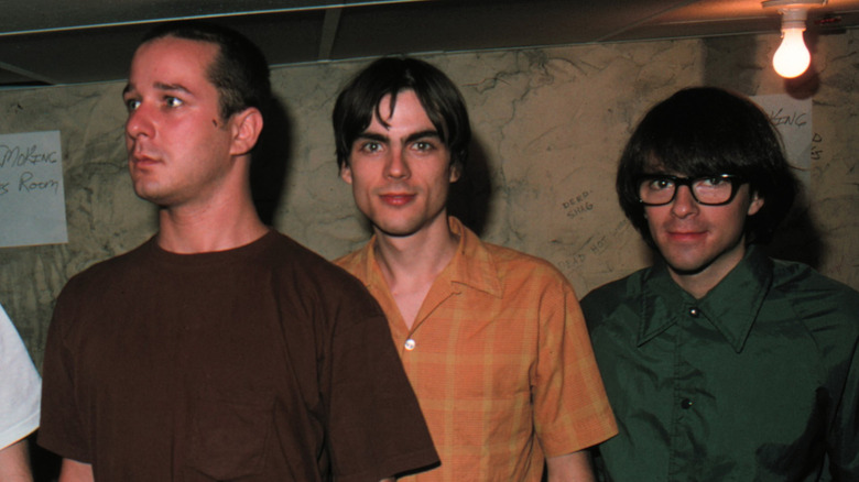 Matt Sharp, Brian Bell, Rivers Cuomo of Weezer in 1994 in dim room