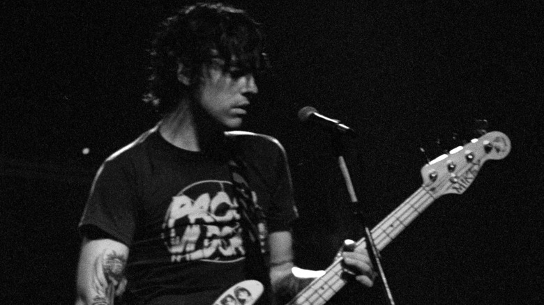 Mikey Welsh playing bass on stage in 2000