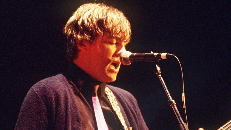 Mikey Welsh singing and playing bass on stage