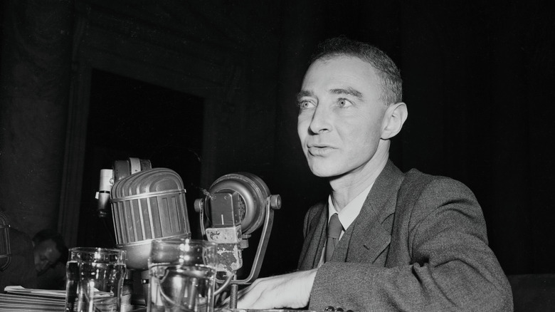 Oppenheimer talking into microphones