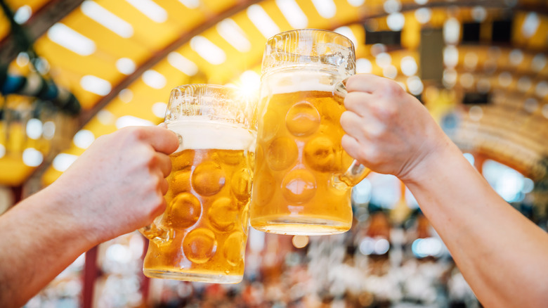 Munich Oktoberfest clashing beer mugs