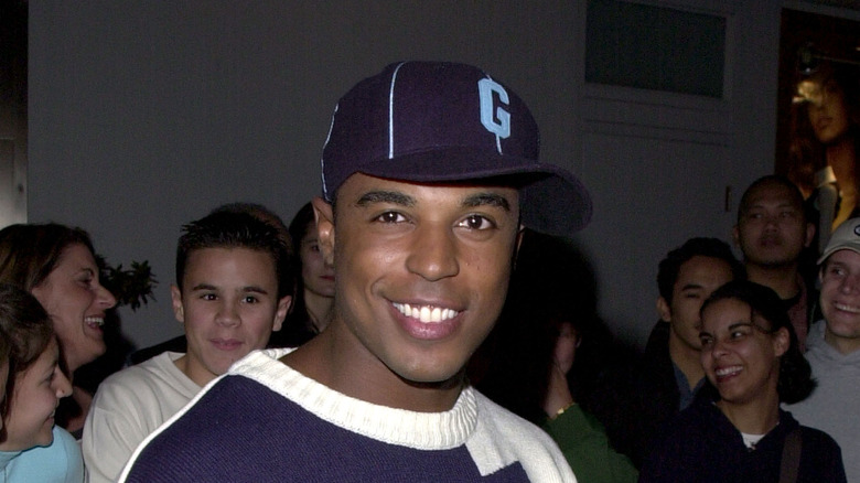 actor Merlin Santana smiling hat